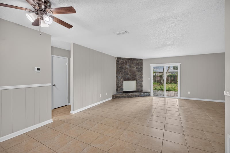 Entry hallway with tile floor and sliding glass door at 1040 Willow Cove Ct E, Jacksonville, FL 32233