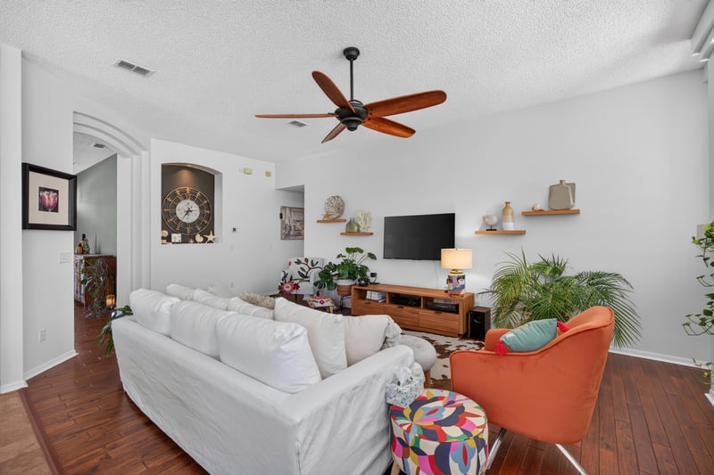 Family room seating area with ceiling fan at 1820 Burgess Hill Dr E, Jacksonville, FL