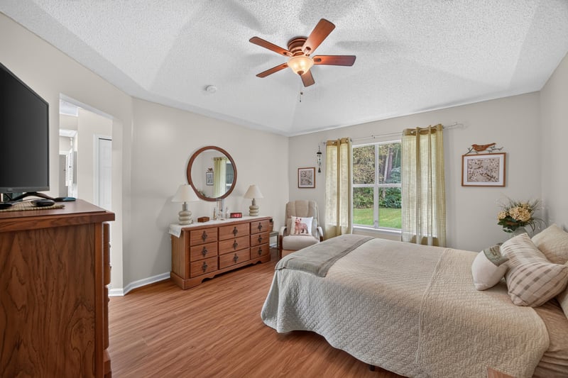 Primary bedroom with wood floors and dresser at 13514 Las Brisas Way N, Jacksonville, FL