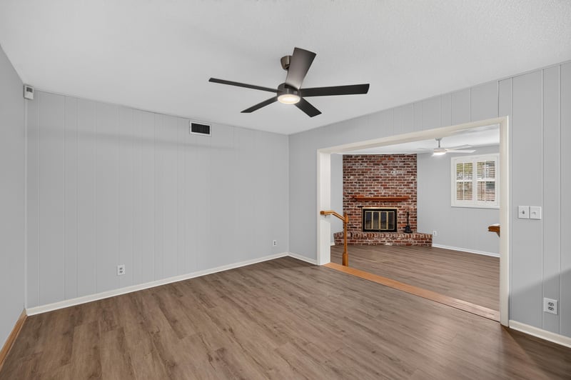 Family room with brick fireplace open to kitchen at 1834 Memory Ln, Jacksonville, FL