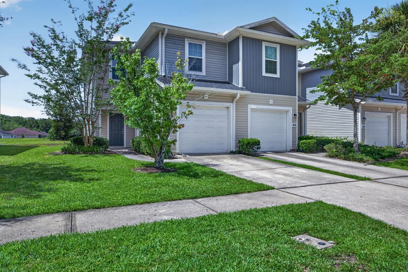 Front exterior view with landscaped lawn and driveway at 1572 Biscayne Bay Dr, Jacksonville, FL 32218