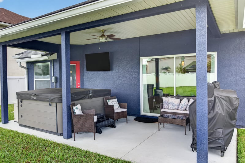 Covered patio with hot tub and outdoor seating at 538 Porta Rosa Circle, St. Augustine, FL 32092