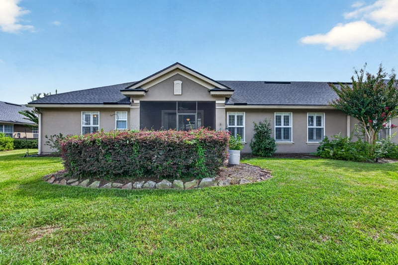 Rear exterior view of home and backyard at 2131 E Stone Creek Dr, Fleming Island, FL