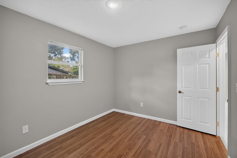 Hallway with window and closet door at 7015 Miss Muffet Ln N, Jacksonville, FL 32210
