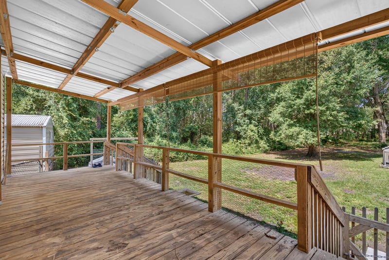 Covered back porch with wood beam ceiling at 2549 Snapdragon Ave, Middleburg, FL 32068