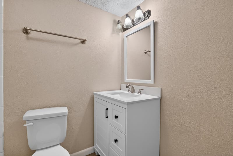 Bathroom vanity with mirror and toilet at 5811 Atlantic Blvd unit 47, Jacksonville, FL 32207