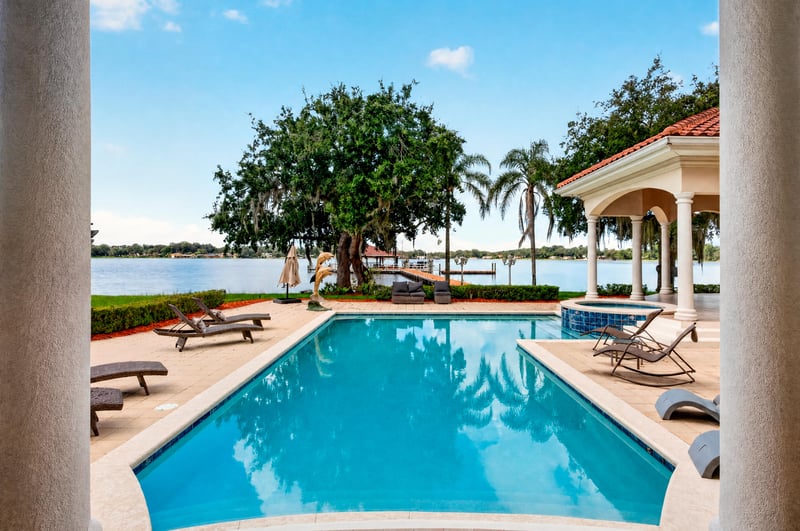 Pool deck with large oak tree and water view at 344 Broward Rd, Jacksonville, FL