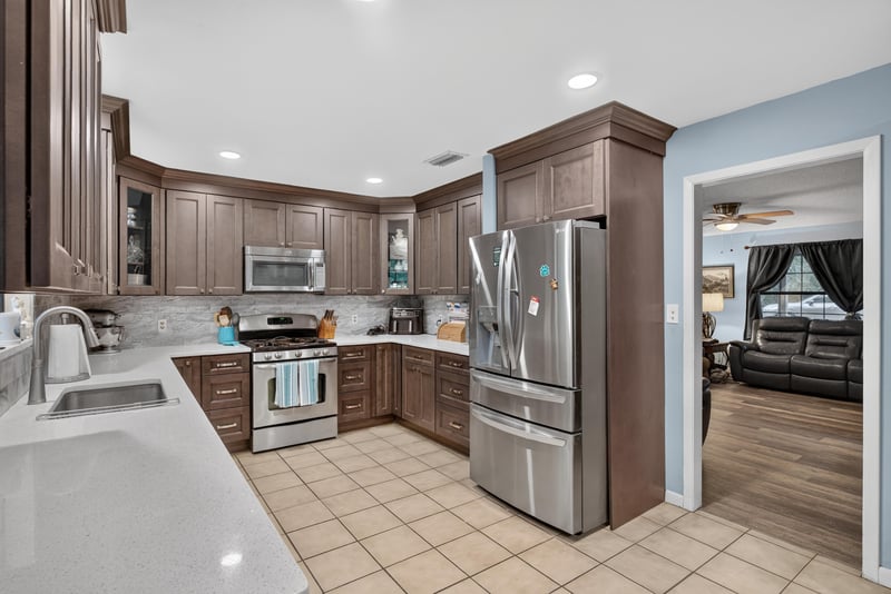 Kitchen view toward living room with stainless refrigerator at 3249 Maryland Ave, Green Cove Springs, FL