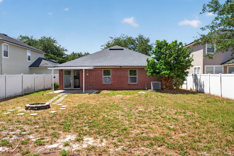 Backyard view of house with fire pit at 224 Pine Arbor Cir, St. Augustine, FL 32084
