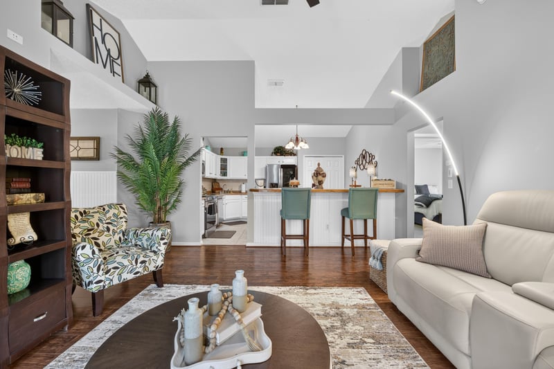 Living room corner with bookshelf and area rug at 3067 Wavering Ln, Middleburg, FL 32068