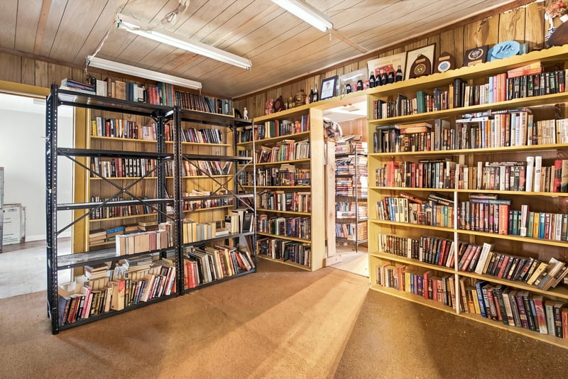 Room filled floor to ceiling with bookshelves at 1807 Idlewild Ave, Green Cove Springs, FL