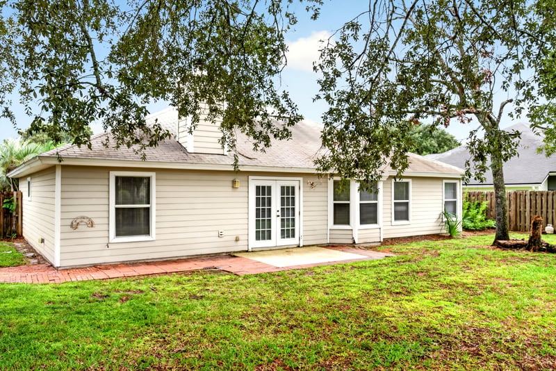 Backyard view of the roofline and trees at 12949 Chets Creek Dr S, Jacksonville, FL 32224