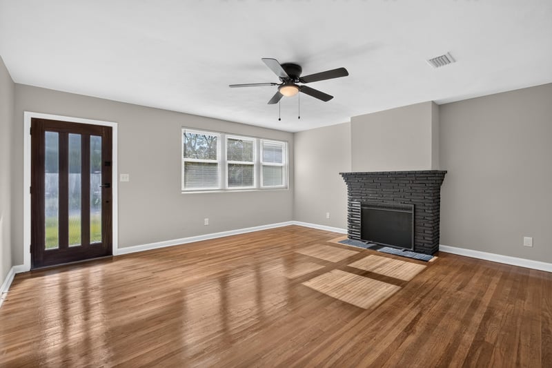 Living room with French doors and fireplace at 6338 Mercer Cir W, Jacksonville, FL
