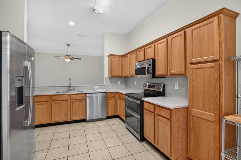 Kitchen with wood cabinets and stainless appliances at 2131 E Stone Creek Dr, Fleming Island, FL