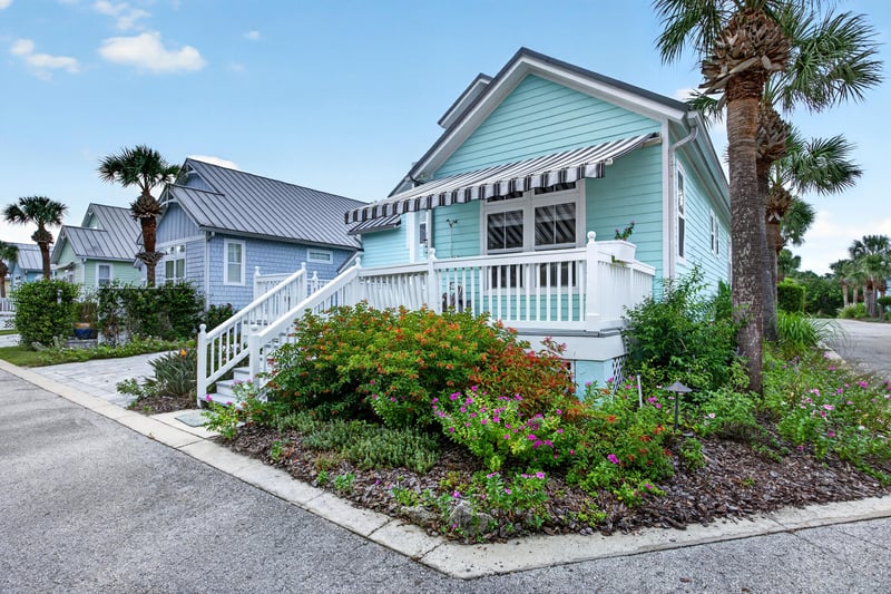 Side exterior with landscaping and awning at 117 Island Cottage Way, St. Augustine, FL 32080