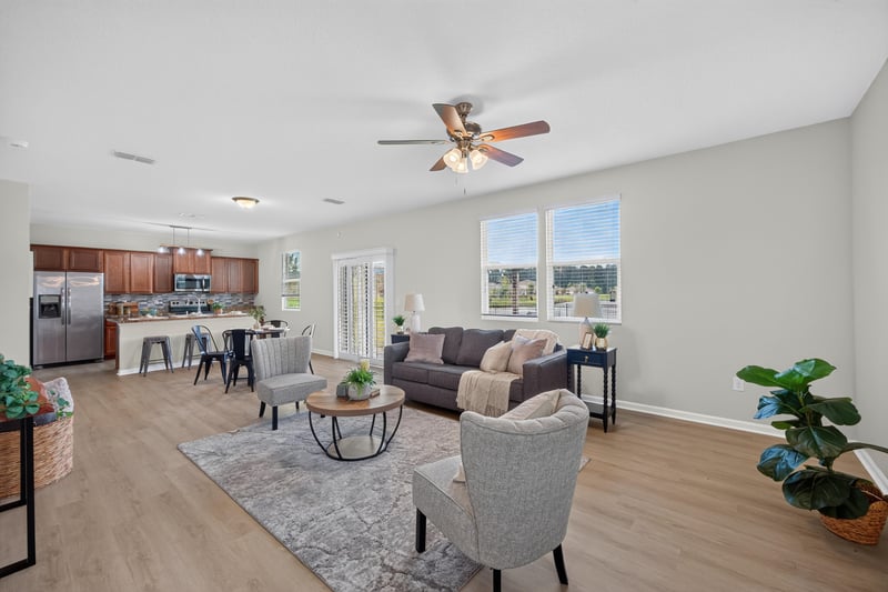 Living room open to the kitchen with sectional sofa at 6830 Hanford St, Jacksonville, FL 32219
