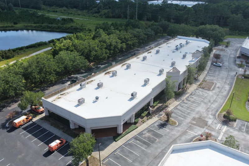 Aerial view of a building roofline with cars in the parking lot at 10550 Deerwood Park Blvd, Jacksonville, FL 32256