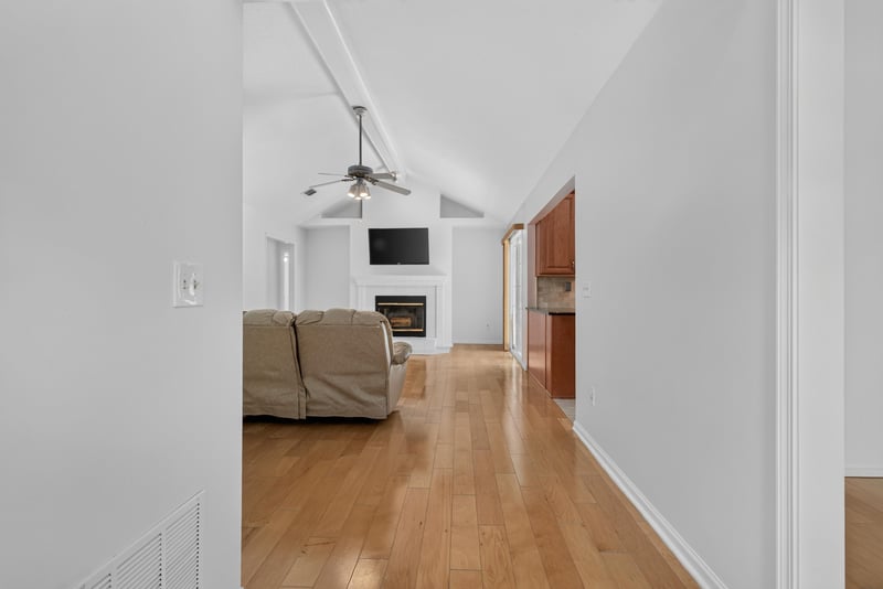 Hallway with wood floors and ceiling fan at 12810 Swamp Owl Ln