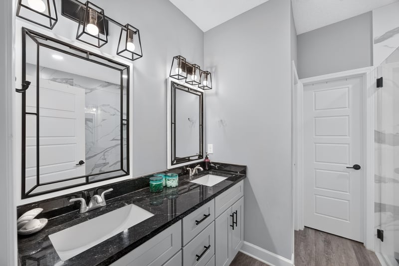 Bathroom with double vanity and black countertop at 2817 Camel Cir, Middleburg, FL