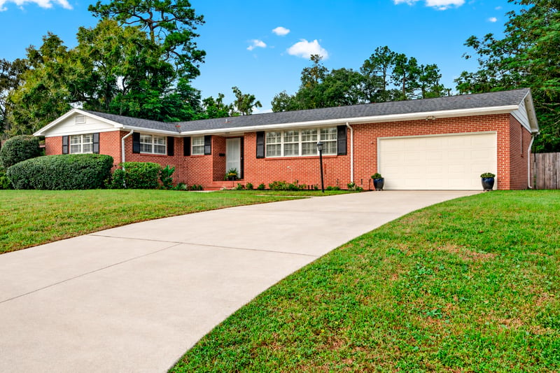 Front exterior with driveway and lawn at 1834 Memory Ln, Jacksonville, FL