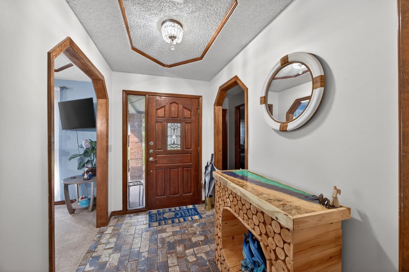 Entry foyer with wood console table and front door at 981 Marble Ridge Dr, Orange Park, FL 32065