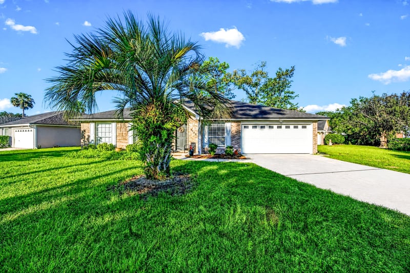 Front yard and driveway with palm tree at 4556 Shaky Leaf Ln N, Jacksonville, FL 32224