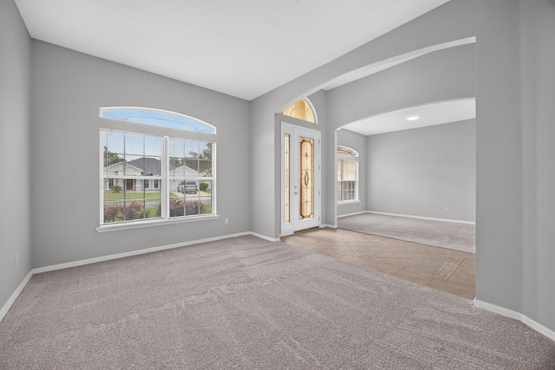 Living room with arched window and carpet at 635 Wakeview Dr, Orange Park, FL 32065