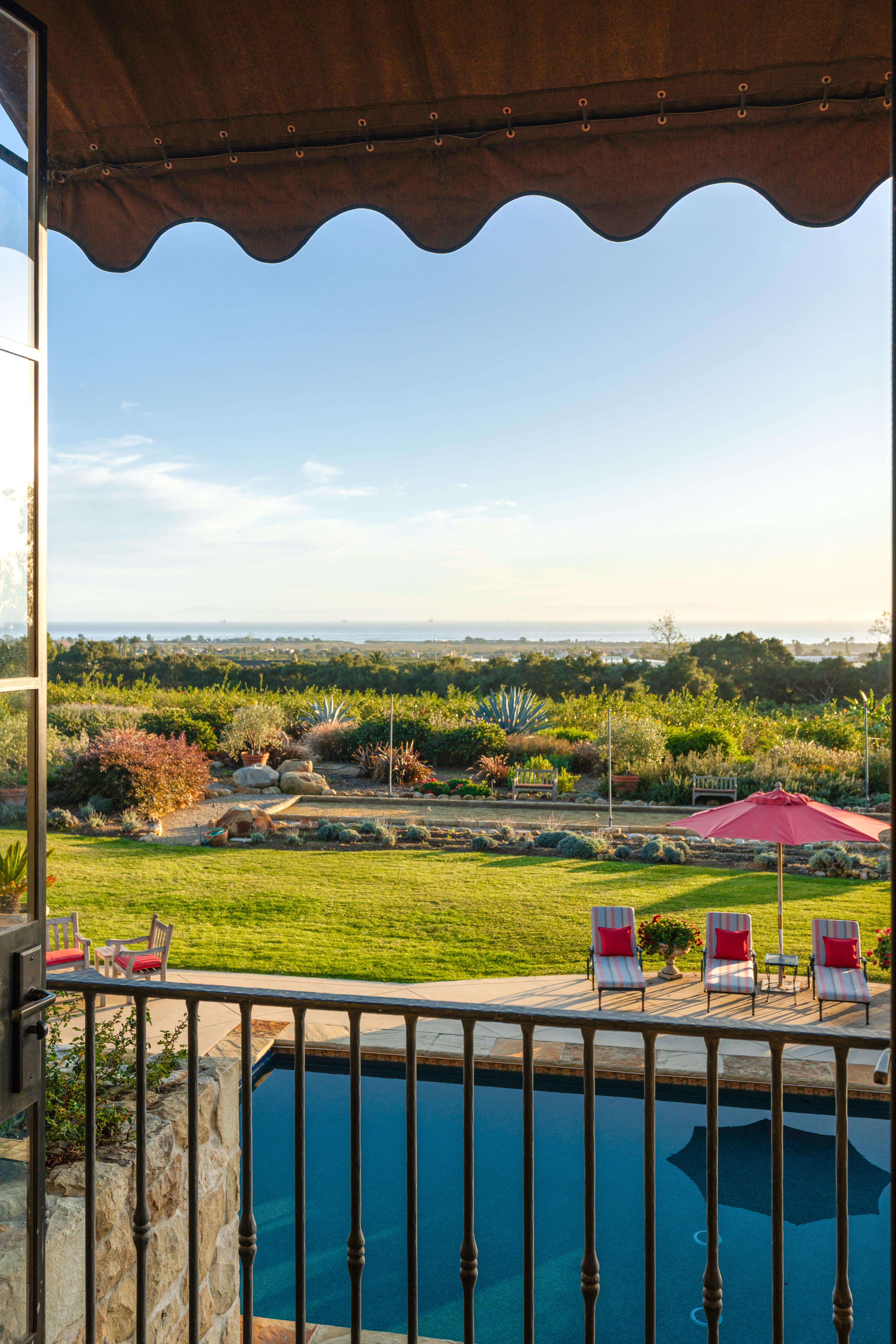 Twilight photography of the illuminated facade at 1915 Monte Alegre Dr, Carpinteria — golden-hour light dissolves into coastal dusk along the American Riviera's most coveted southern corridor. Our team captured editorial photography, aerial drone photography via Inspire 3 Cinema Drone, a cinematic property video, a true vertical social media reel, and twilight photography from midday through twilight.