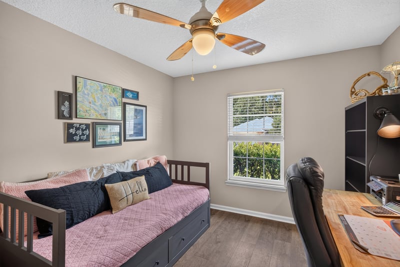 Bedroom with daybed and wall art at 1589 Backwater Drive, Middleburg, FL 32068