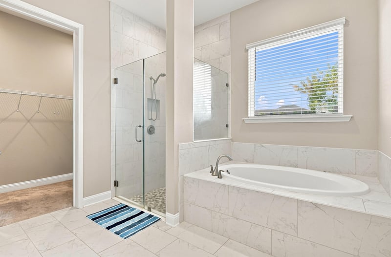 Primary bathroom shower and soaking tub with window at 27 Holly Rdg Wy, St. Augustine, FL