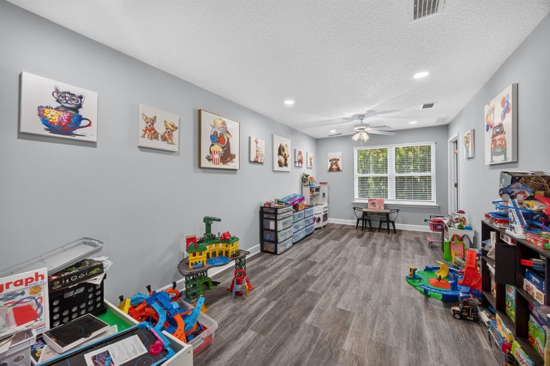 Playroom with toys and wood-look flooring at 2817 Camel Cir, Middleburg, FL