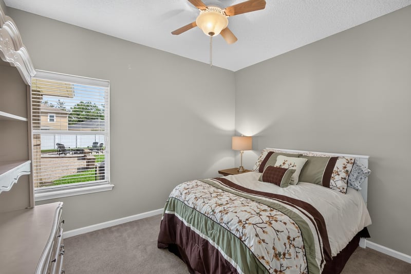 Bedroom with floral bedding and a large window at 3660 Middlebrook Dr, Orange Park, FL 32065