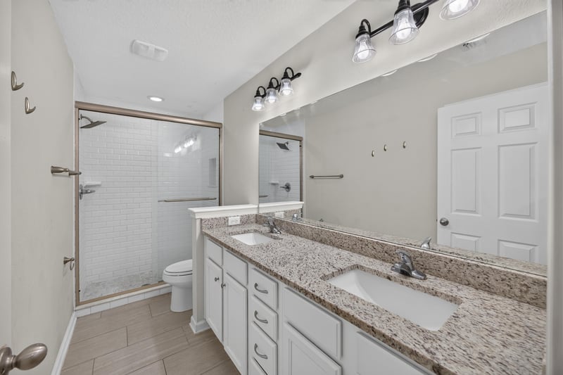 Bathroom with granite vanity and double sink at 1002 Ingleside Ave, Jacksonville, FL 32205