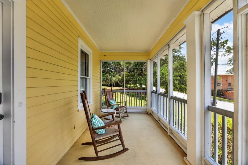 Screened porch with rocking chairs at 101 N Lake St, Crescent City, FL