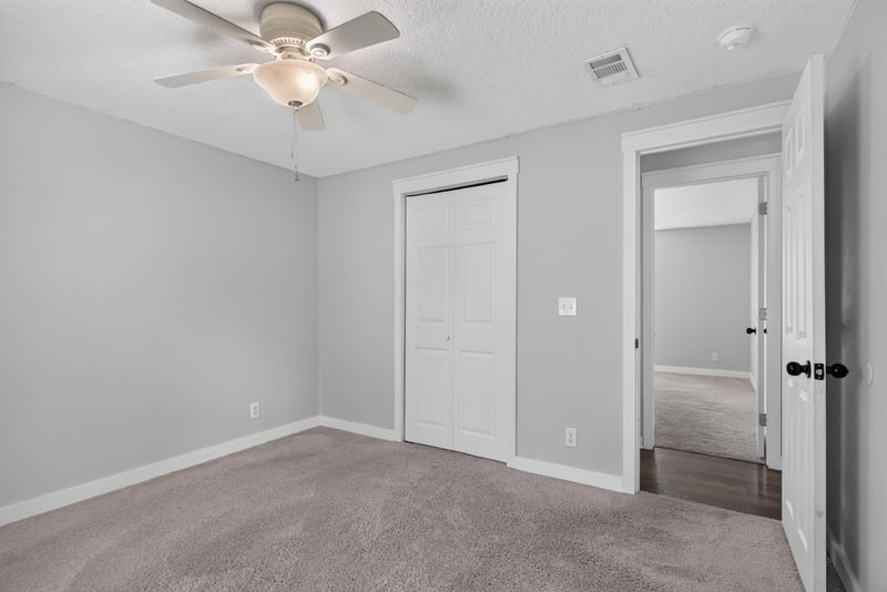 Bedroom with carpet and closet doors at 4890 McAllister Rd, Middleburg, FL 32068