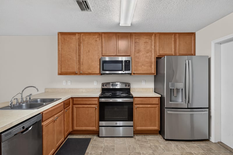 Kitchen with wood cabinets and stainless steel appliances at 7723 Playschool Ln, Jacksonville, FL
