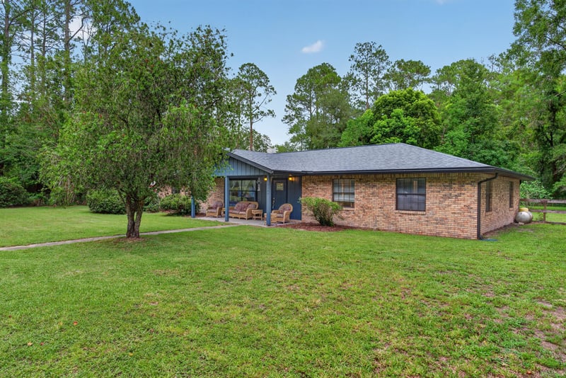 Front yard and walkway leading to brick home at 3249 Maryland Ave, Green Cove Springs, FL