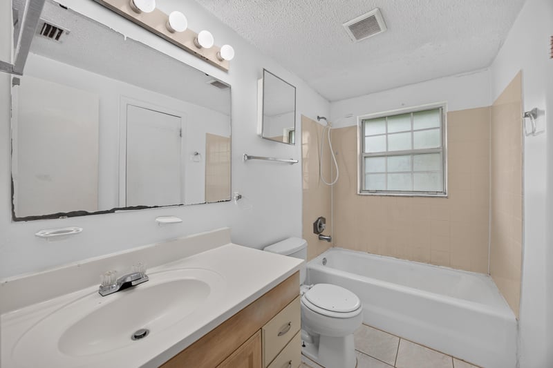 Bathroom with vanity mirror and tub-shower at 5812 Tampico Rd, Jacksonville, FL 32244