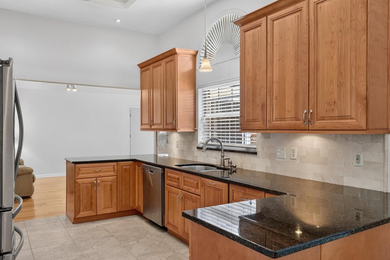 Kitchen with wood cabinets and dishwasher at 12810 Swamp Owl Ln
