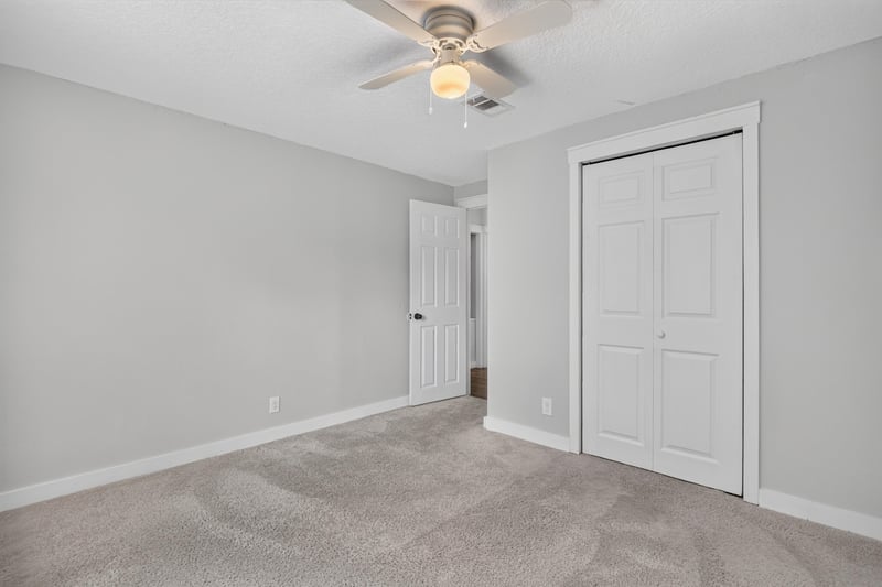 Bedroom with carpet and closet door at 4890 McAllister Rd, Middleburg, FL 32068