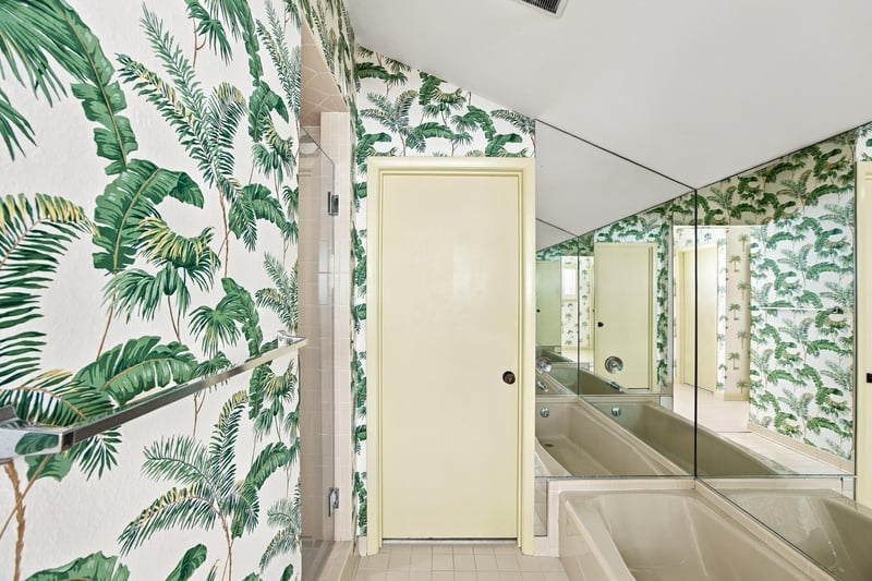 Bathroom with mirrored closet doors and palm wallpaper at 752 Spinnakers Reach Dr, Ponte Vedra Beach, FL 32082
