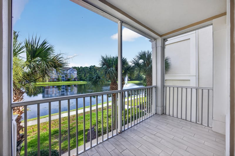 Screened balcony with water and palm tree view at 11251 Campfield Dr unit 4209, Jacksonville, FL 32256