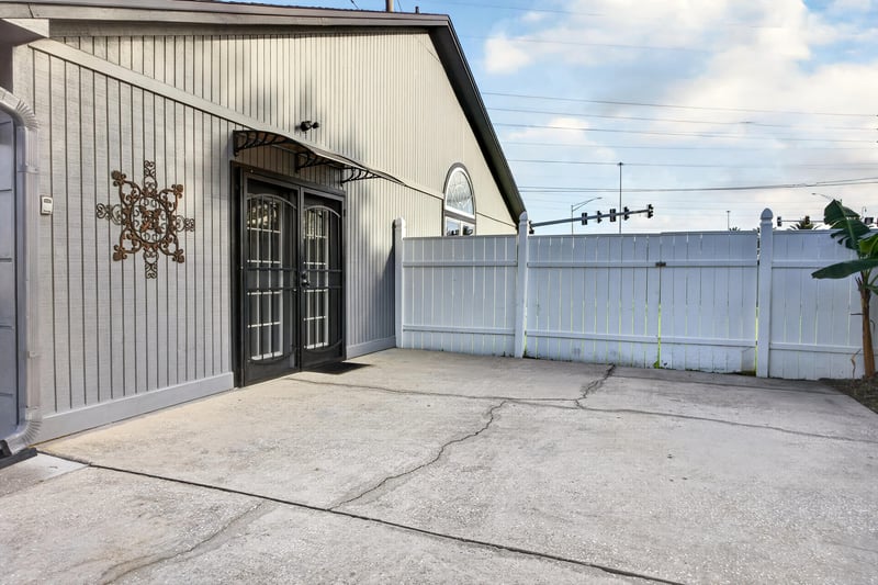 Detached garage with large door open at 6931 Cane Grass Ln E, Jacksonville, FL 32244
