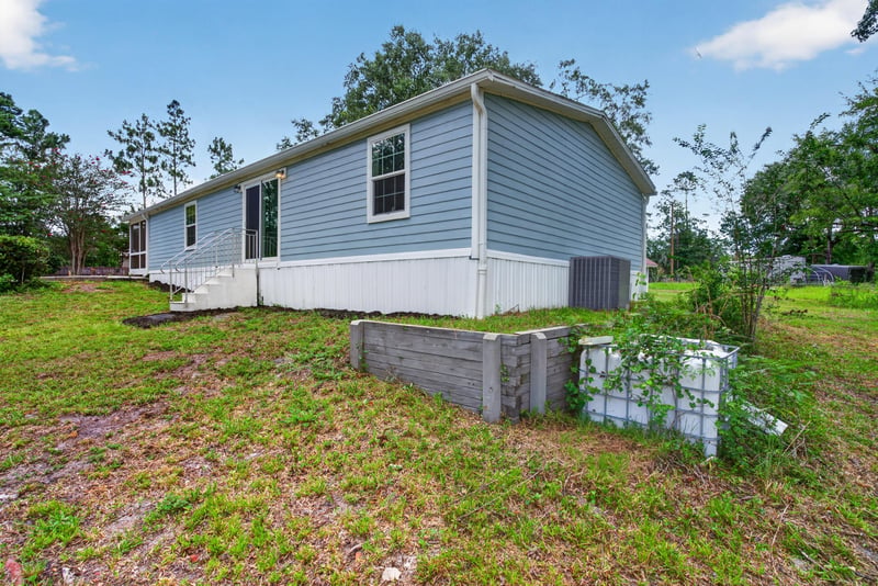 Aerial side view of the home and yard at 4890 McAllister Rd, Middleburg, FL 32068
