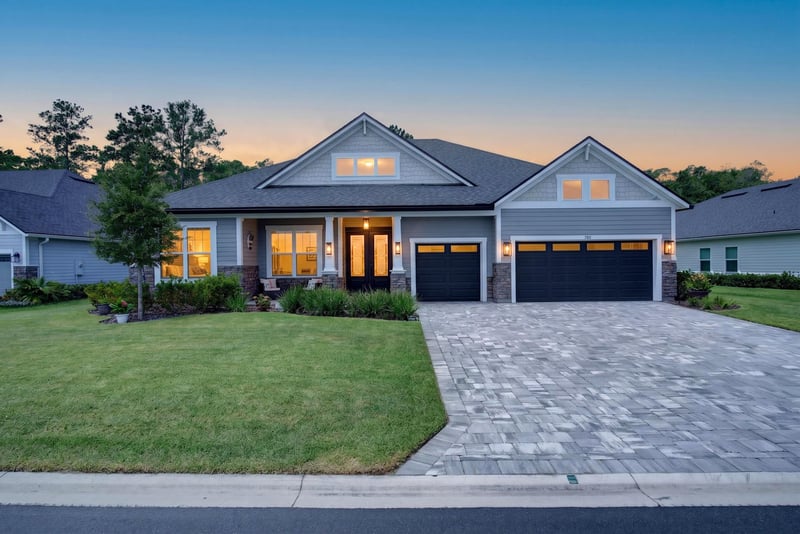 Front exterior at day-to-dusk with three-car garage at 785 Back Creek Dr, St. Augustine, FL 32092
