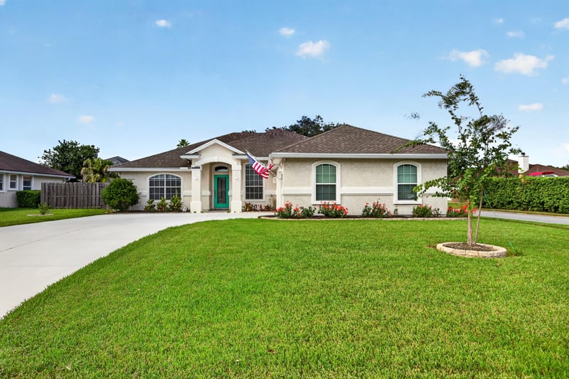 Front exterior with tile roof and wide lawn at 12825 Kelsey Island Dr, Jacksonville, FL 32224