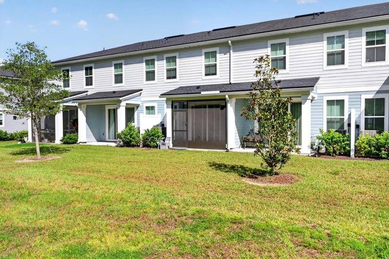 Rear exterior with lawn and attached townhomes at 39 Mellowood Ln, St. Augustine, FL 32092