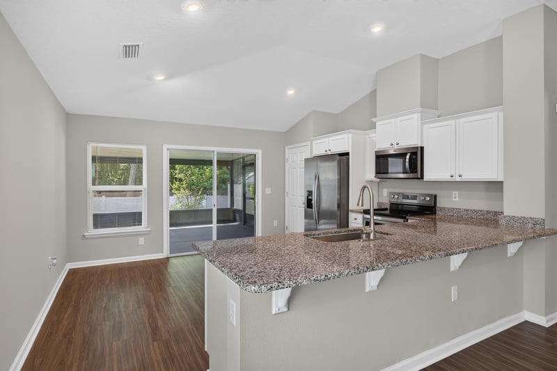 Kitchen with stainless refrigerator and bar seating at 7118 Preston Pnes Trl, Jacksonville, FL