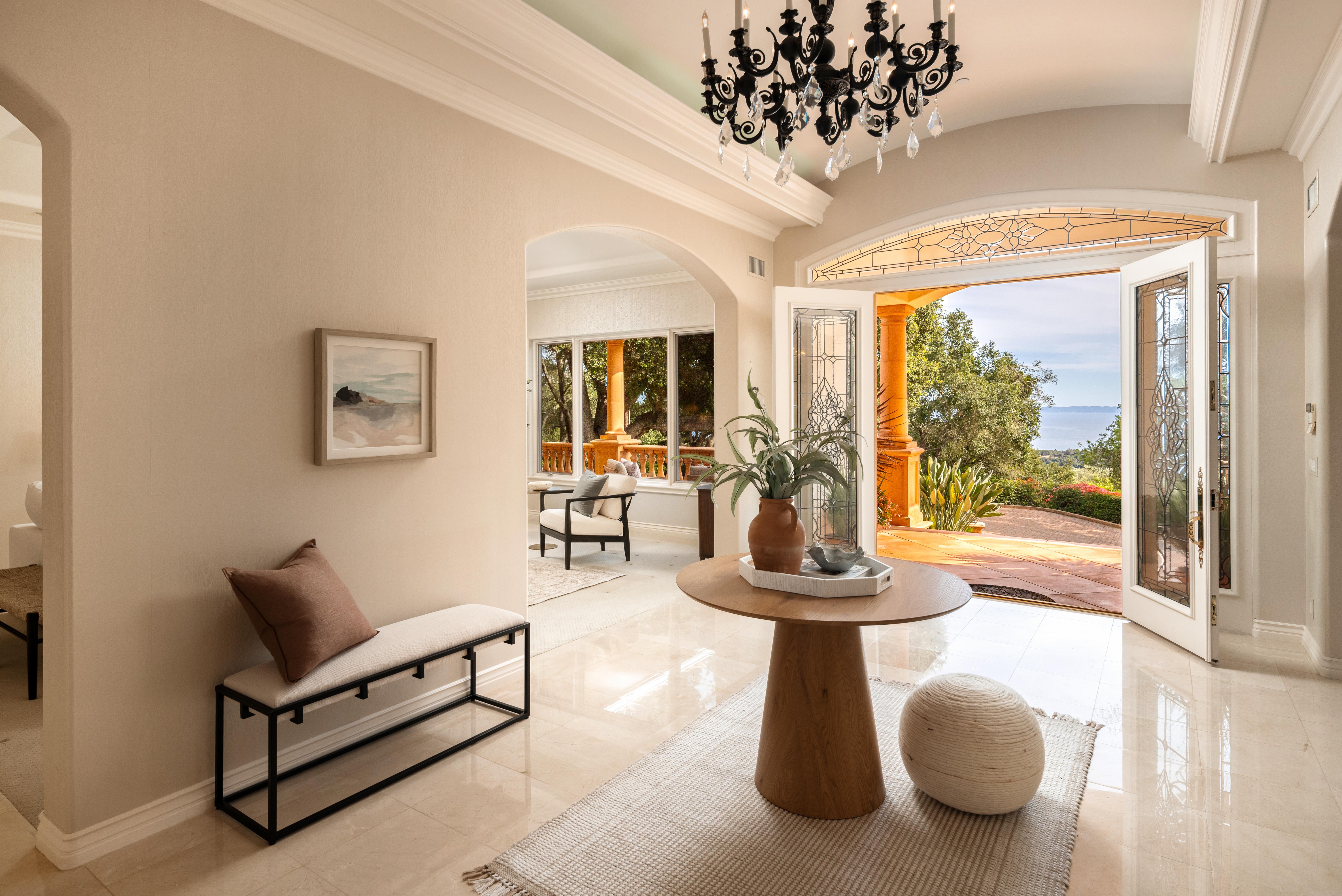 Aerial drone photography of hillside property grounds at 450 El Cielito Rd, Santa Barbara — real estate drone photography documenting terraced outdoor spaces, pool, and Santa Ynez Mountain backdrop along the Southern California coast. Our team captured still photography, aerial drone photography, twilight photography, a Matterport virtual tour, a 2D floor plan, and a custom property website from afternoon through twilight.