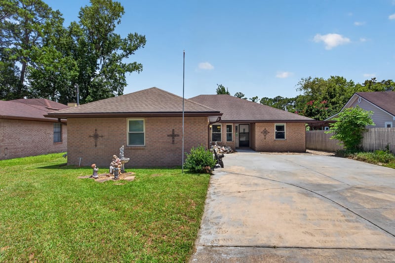 Front exterior with flagpole and brick facade at 2460 San Sago Ln, Jacksonville, FL
